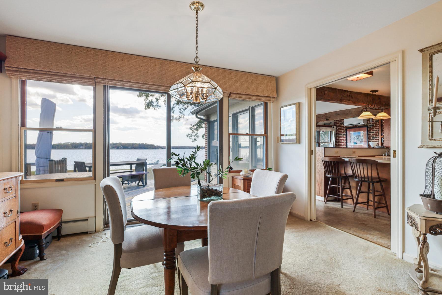 3258 Harness Creek Road Annapolis, MD 21403 - Photo 23 of 34 a dining room with furniture mountain view and a chandelier