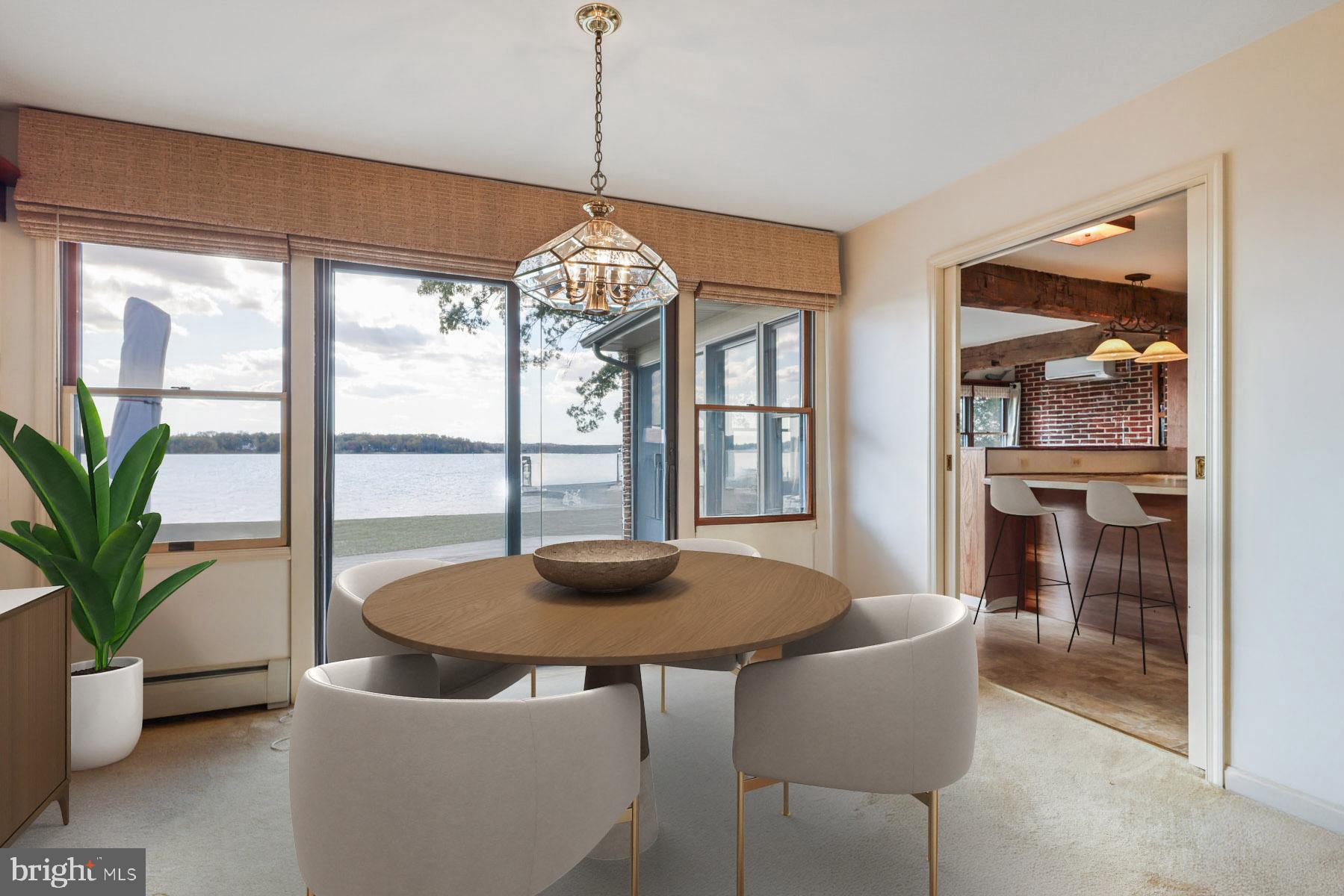 3258 Harness Creek Road Annapolis, MD 21403 - Photo 24 of 34 a dining room with furniture wooden floor and a chandelier