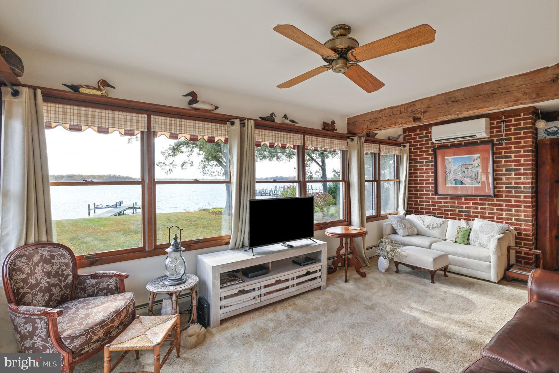 3258 Harness Creek Road Annapolis, MD 21403 - Photo 27 of 34 a living room with furniture a flat screen tv and a large window