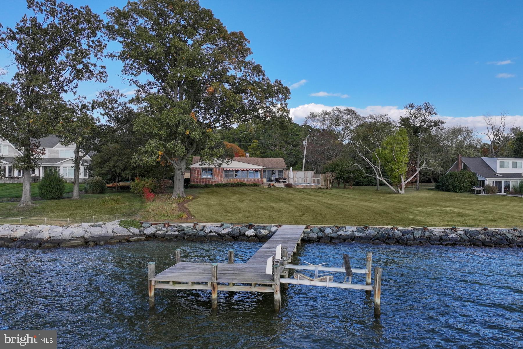 3258 Harness Creek Road Annapolis, MD 21403 - Photo 3 of 34 a view of a lake with a yard and large trees