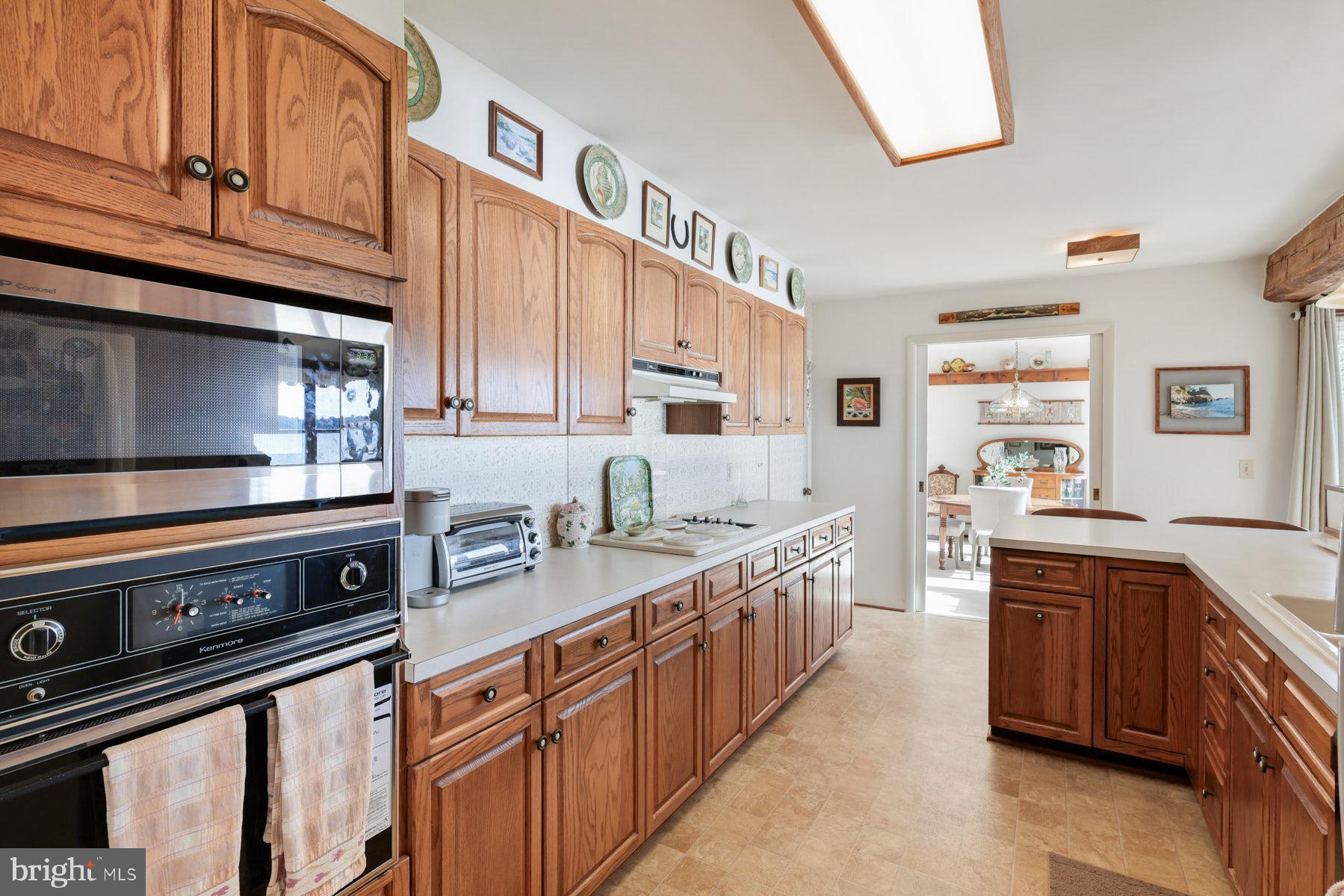 3258 Harness Creek Road Annapolis, MD 21403 - Photo 31 of 34 a kitchen with stainless steel appliances granite countertop a stove a sink and a microwave