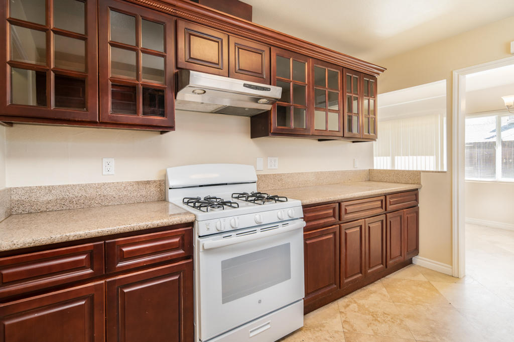 45546 3rd Street East Lancaster, CA 93535 - Photo 11 of 23 a kitchen with stainless steel appliances granite countertop a stove and a microwave