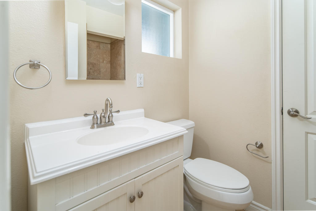 45546 3rd Street East Lancaster, CA 93535 - Photo 13 of 23 a bathroom with a sink toilet and vanity