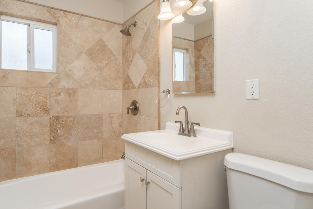 45546 3rd Street East Lancaster, CA 93535 - Photo 19 of 23 a bathroom with a sink a toilet and shower