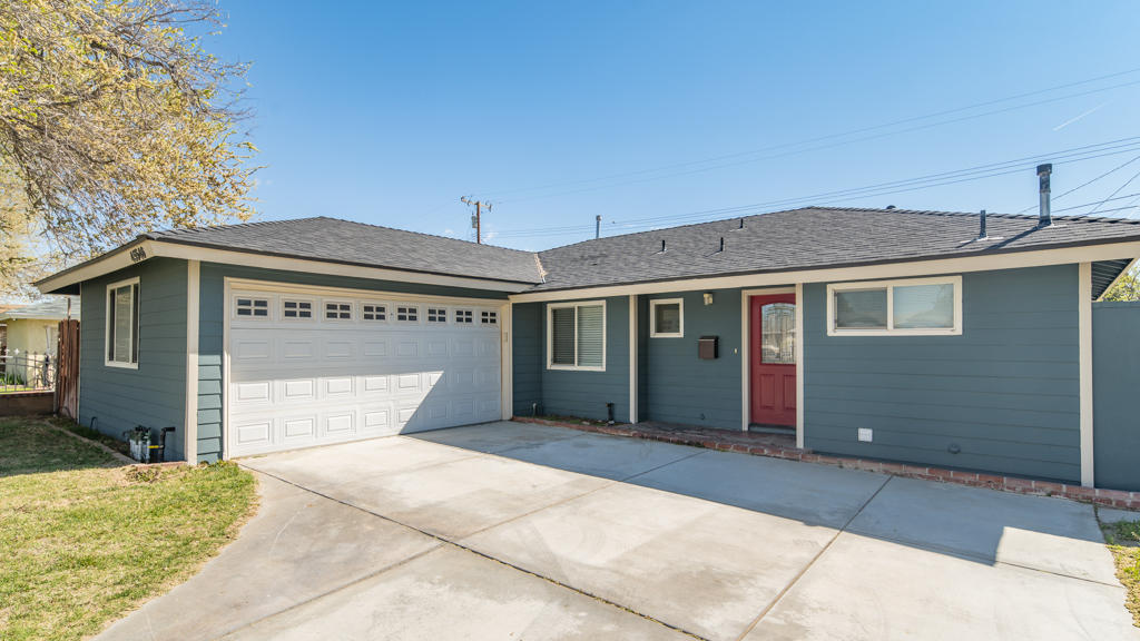 45546 3rd Street East Lancaster, CA 93535 - Photo 3 of 23 a front view of a house with a garage