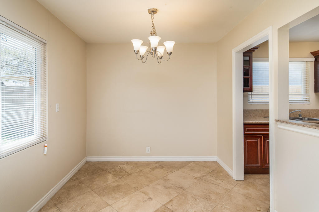 45546 3rd Street East Lancaster, CA 93535 - Photo 8 of 23 a view of kitchen with chandelier and refrigerator