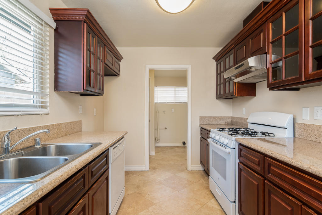 45546 3rd Street East Lancaster, CA 93535 - Photo 9 of 23 a kitchen with stainless steel appliances granite countertop a sink and a stove