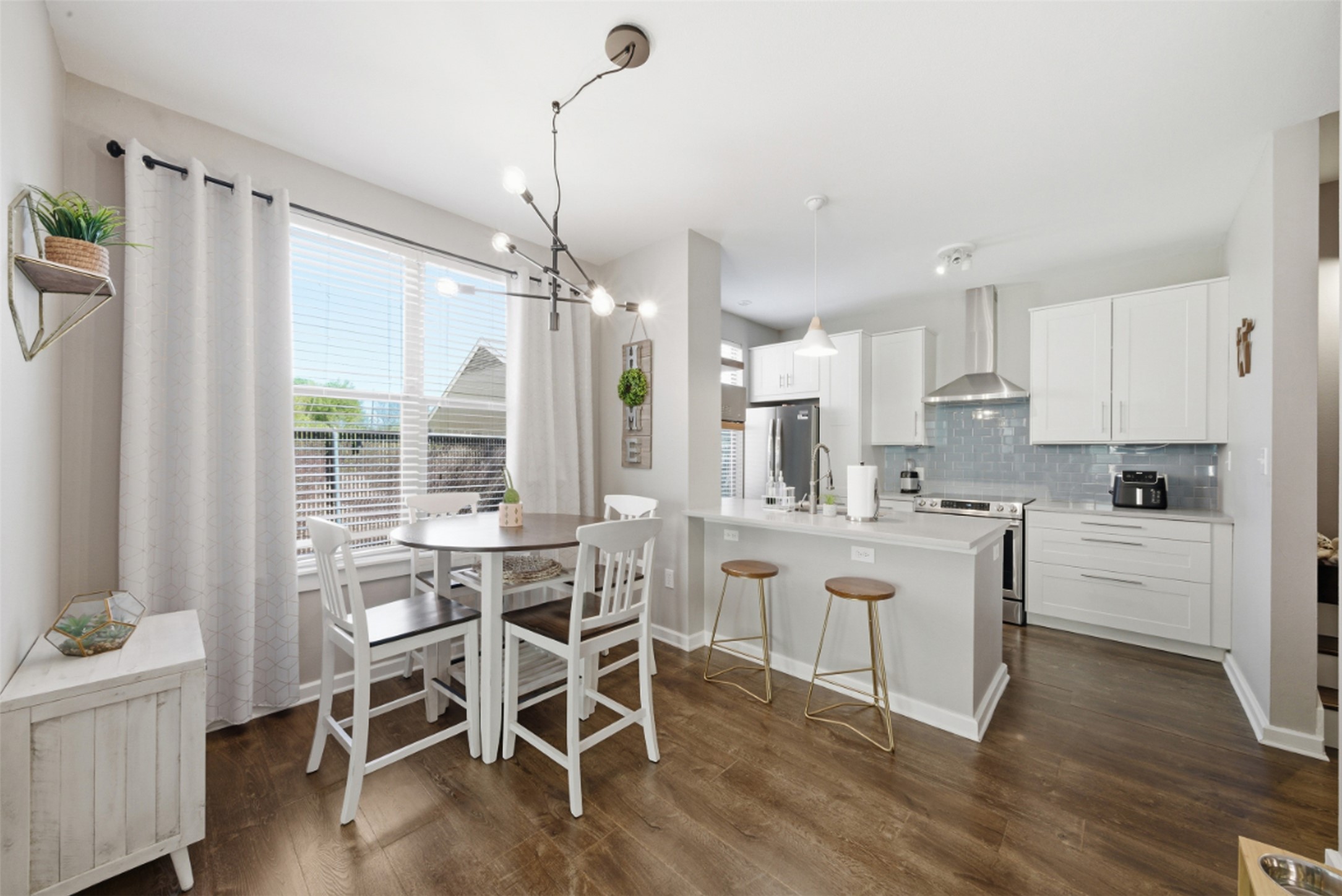 1201 Grove Boulevard, Unit 1304 Austin, TX 78741 - Photo 5 of 19 a kitchen with stainless steel appliances a dining table chairs and wooden floor