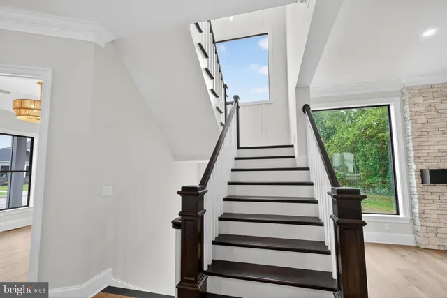 a view of a kitchen with wooden floor and a large window