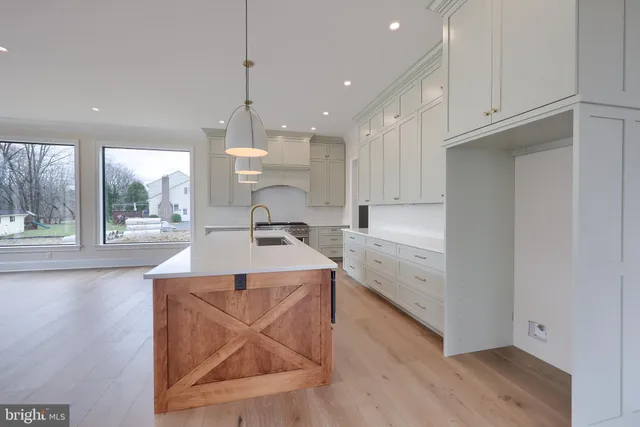 a large kitchen with a large stove top oven and cabinets