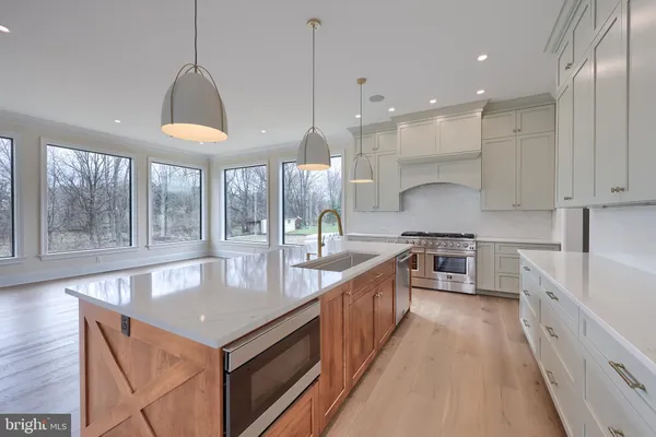 a stove top oven sitting inside of a kitchen