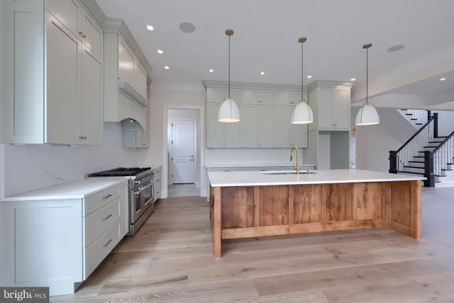 a stove top oven sitting inside of a kitchen