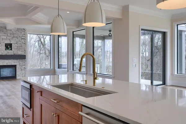 a view of a kitchen with an entryway and wooden floor