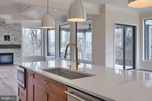 a view of a kitchen with an entryway and wooden floor