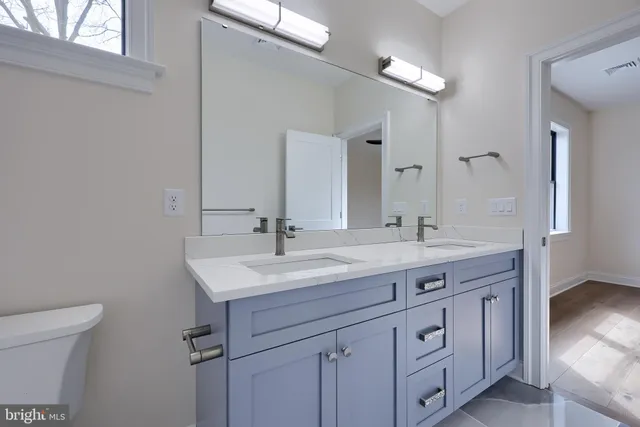 an empty room with wooden floor and window