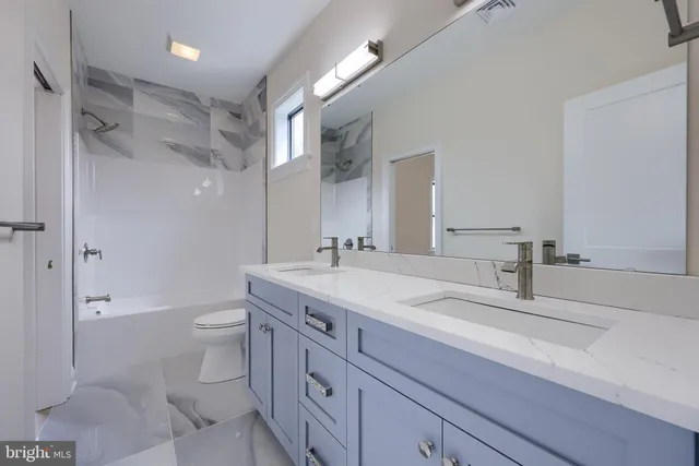 a kitchen with granite countertop white cabinets and a sink