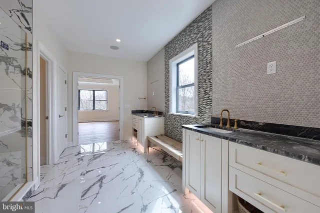 a view of a livingroom with furniture and floor to ceiling window