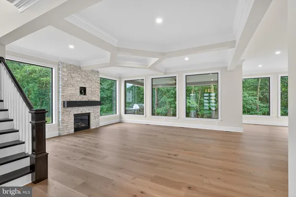 a view of an empty room with a fireplace and a window