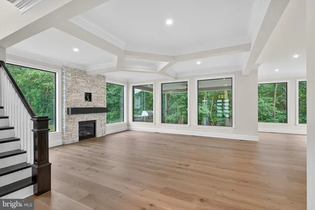 a view of an empty room with a fireplace and a window