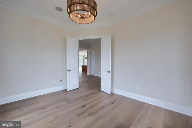a view of a room with wooden floor