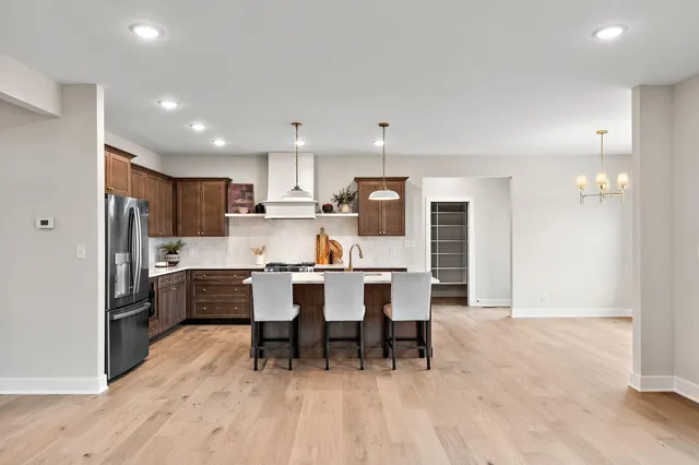 a large kitchen with a table and chairs