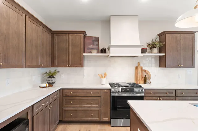 a kitchen with a sink a stove and cabinets