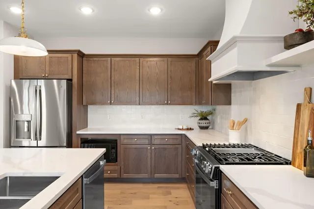 a kitchen with a stove and a refrigerator