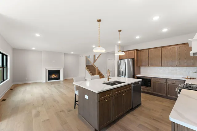 a kitchen with a stove and a wooden floor