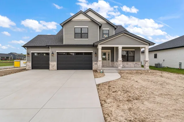 a front view of a house with yard and garage