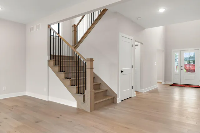 a view of staircase with white walls and a window
