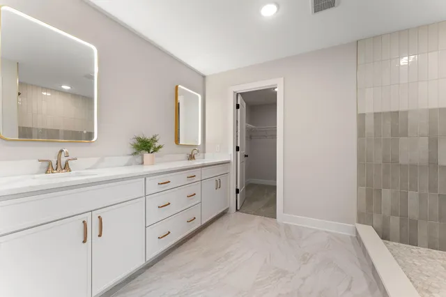 a spacious bathroom with double sink and a mirror