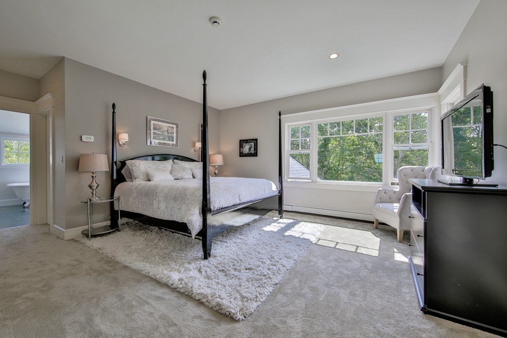44 Walker Road Manchester, MA 01944 - Photo 21 of 30 a spacious bedroom with a bed and a large window