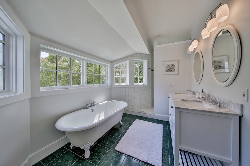 44 Walker Road Manchester, MA 01944 - Photo 22 of 30 a bathroom with a toilet a sink a mirror and a window