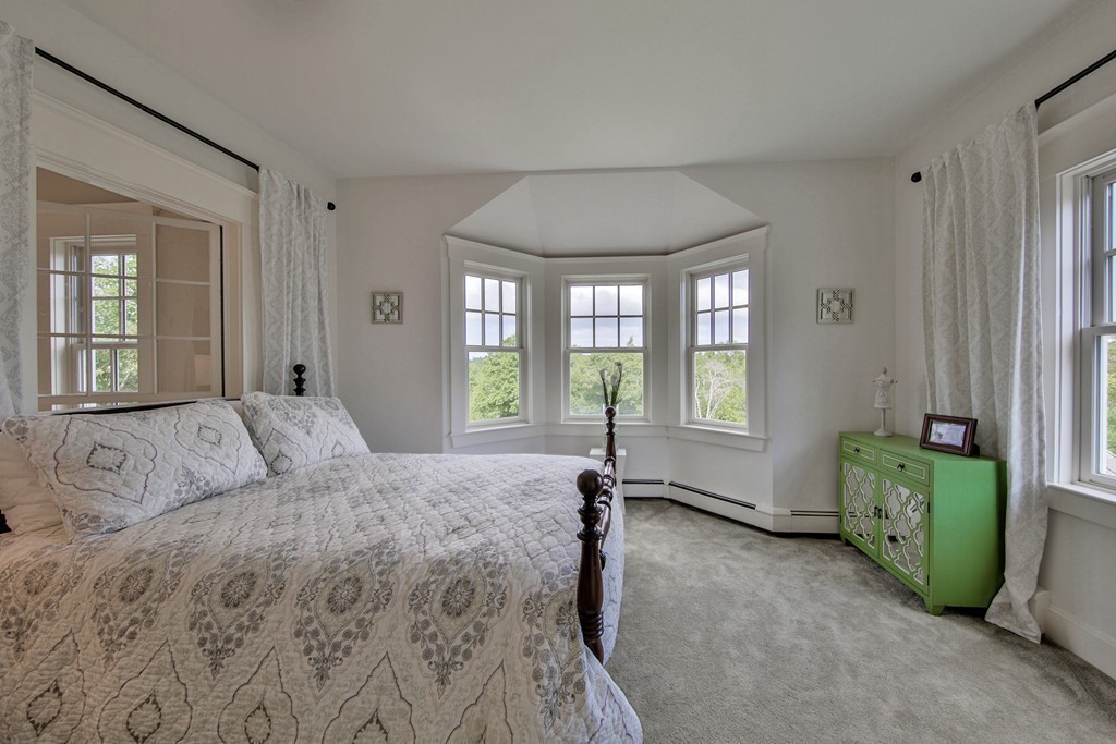 44 Walker Road Manchester, MA 01944 - Photo 25 of 30 a bed sitting in a spacious bedroom next to a window