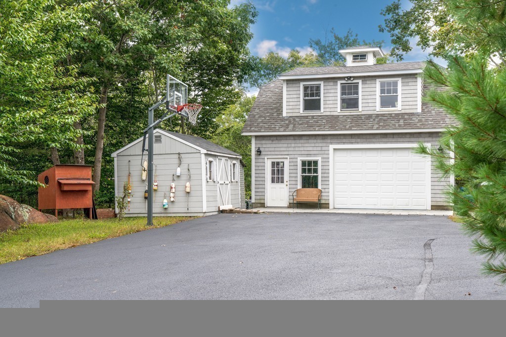 44 Walker Road Manchester, MA 01944 - Photo 8 of 30 a front view of a house with a yard and garage