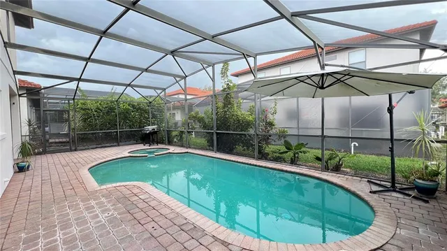 a view of a backyard with a swimming pool