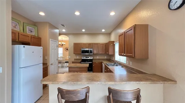a living room with furniture a flat screen tv and a window