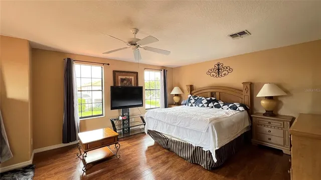 a view of a hallway with workspace and a window