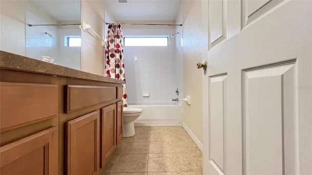 a living room with furniture a window and a dresser