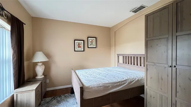 a bedroom with a bed and a table in it