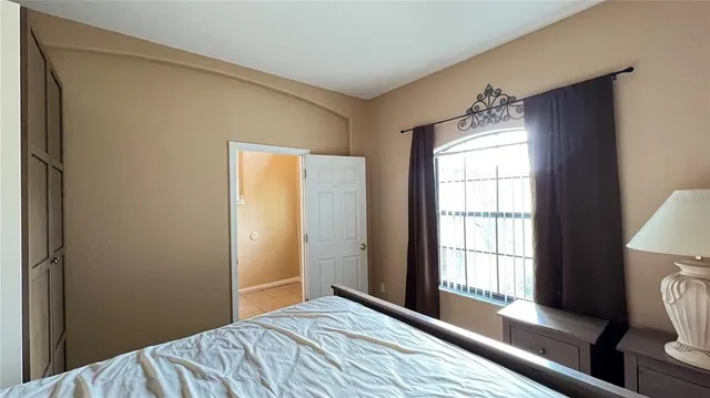 a bedroom with a bed and a window