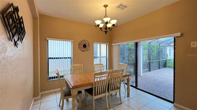 a view of a dining room with furniture wooden floor and chandelier