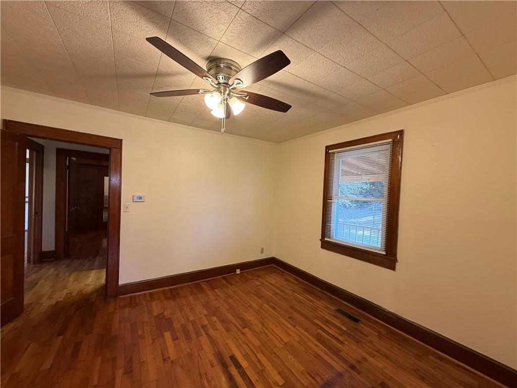 3329 Alabama Highway Rome, GA 30165 - Photo 19 of 32 an empty room with wooden floor chandelier fan and windows