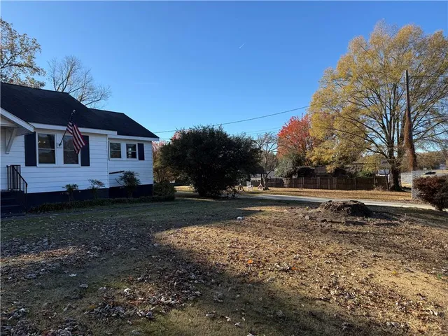 a view of a yard with a house in the background
