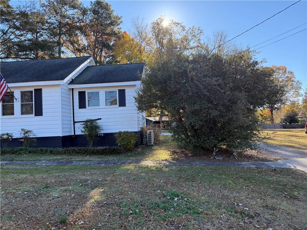 3329 Alabama Highway Rome, GA 30165 - Photo 6 of 32 a view of a brick house next to a yard with large trees