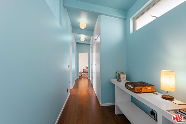 a bedroom with a bed and painting on the wall