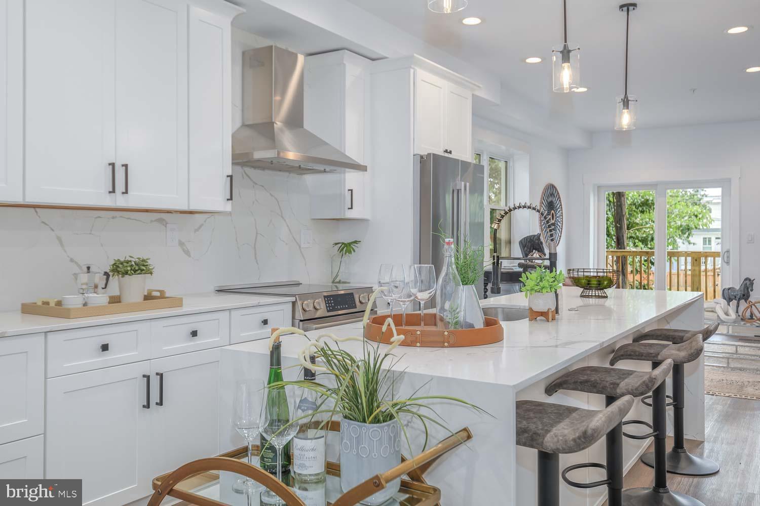 424 Taylor Street Northwest, Unit 1 Washington, DC 20011 - Photo 16 of 53 a outdoor kitchen with white cabinets and stainless steel appliances