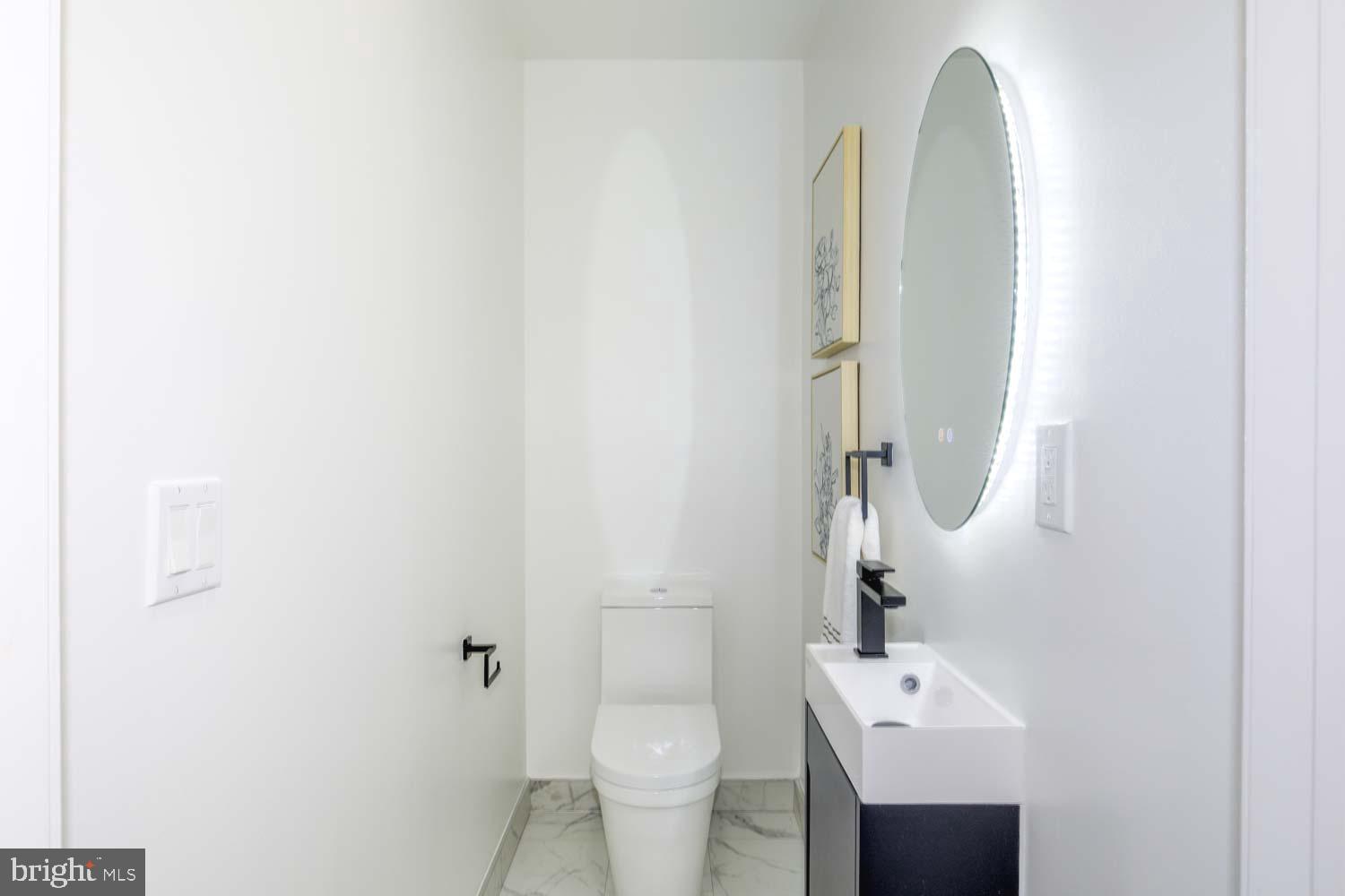 424 Taylor Street Northwest, Unit 1 Washington, DC 20011 - Photo 28 of 53 a bathroom with a toilet sink and mirror