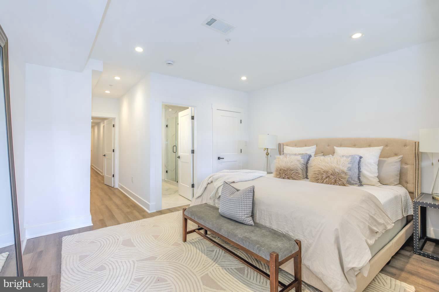 424 Taylor Street Northwest, Unit 1 Washington, DC 20011 - Photo 30 of 53 a spacious bedroom with a bed and a dresser