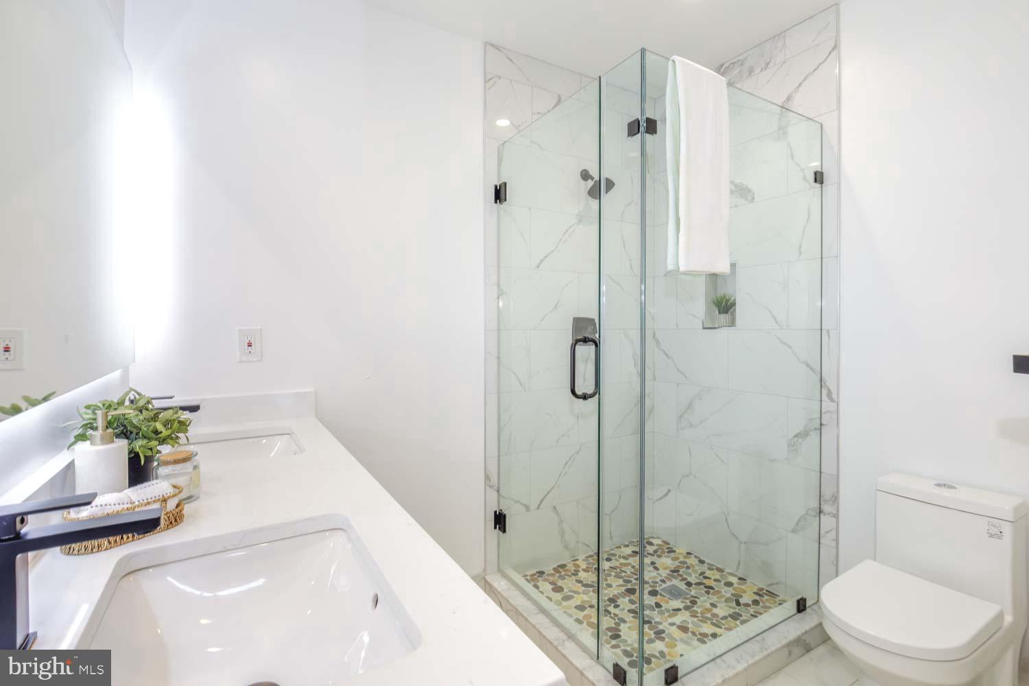 424 Taylor Street Northwest, Unit 1 Washington, DC 20011 - Photo 36 of 53 a bathroom with a sink a toilet and shower